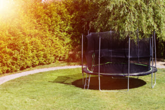 Trampoline in the backyard. Trampoline on the lawn. Leisure. Entertainment, Sports, Game