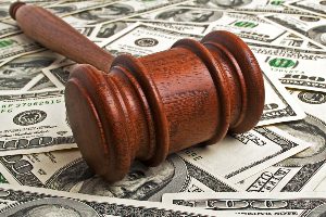 a gavel sits atop a bed of cash