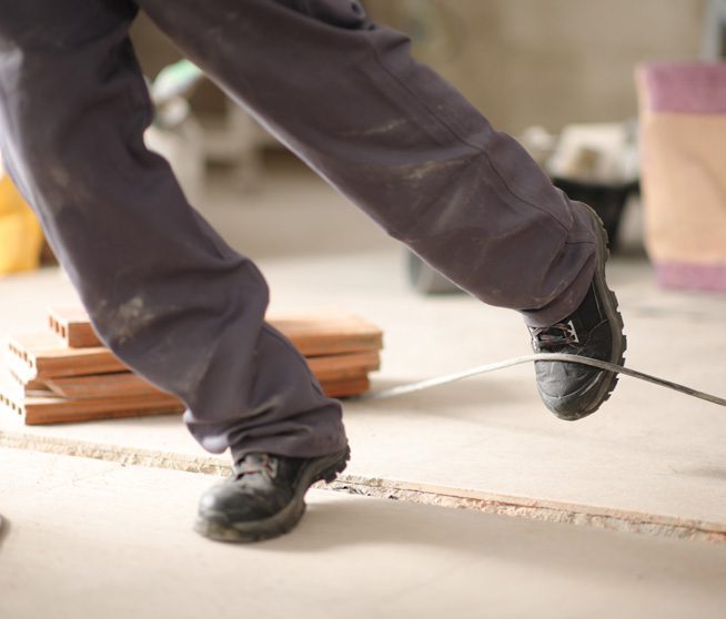 worker stumbling with a cord