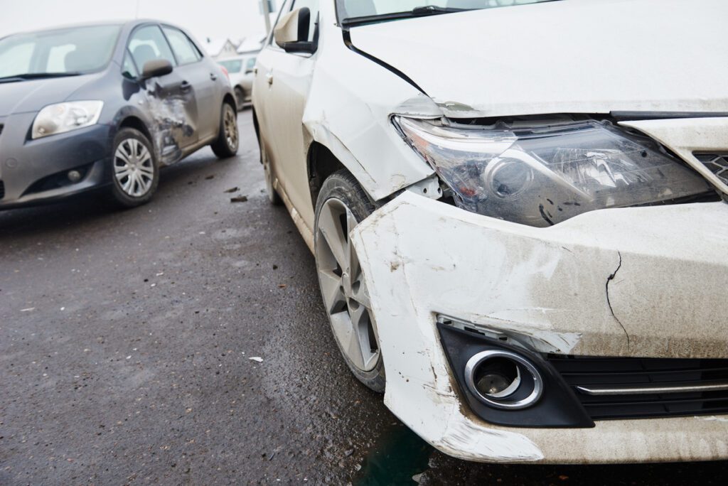 car crash accident on street, damaged automobiles after collision in city