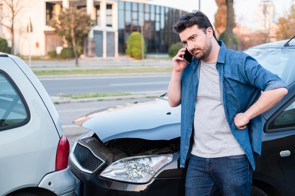 man filing a report for a car crash in Denver and in need of Denver car accident lawyer